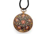 a black and gold necklace with a floral design on it