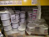 many buckets of paint sitting on a shelf in a store