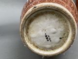 a brown and white vase sitting on a table