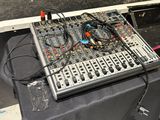 a table that has a keyboard and a mixer on it