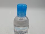 a small bottle of water sitting on a table