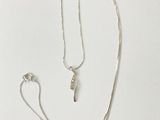 silver plated necklace and earring set on a white background