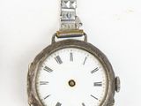 two watches sitting next to each other on a white surface