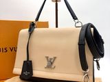 the louis vuitton bag is sitting on a table next to a box