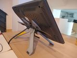 a computer monitor sitting on top of a wooden desk