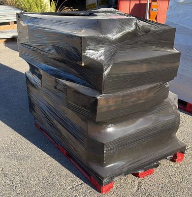 a stack of black plastic bags sitting on a pallet