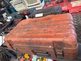 a brown suitcase sitting on top of a pile of assorted items