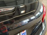 a close up of a car ' s rear end with a sticker on it