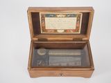 a wooden box with a musical box inside of it