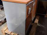 a small refrigerator sitting on a pallet in a warehouse