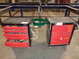 two red drawers with tools on them in a garage