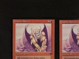 two cards that have a picture of a demon on them