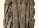 an image of a fur coat hanging on a hanger