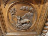a wooden clock with a bird and a bird on it