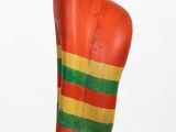 sculpture of a red torso with a green, yellow, and red stripe on it