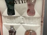 three bottles of perfume in a box on a table
