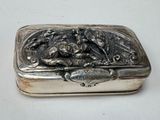 a silver box that has a picture of a dog on it