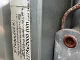 a close up of a metal door handle with a label on it