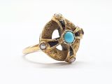 an image of a gold ring with a turquoise stone in the center