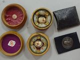 four small wooden boxes that have various items in them