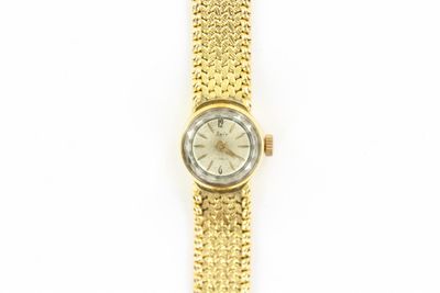 an image of a woman ' s wrist watch with a gold bracelet