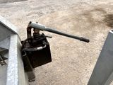 a close up of a metal object on the side of a road