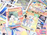 a pile of disney comics on the ground