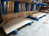 many pieces of wood on the shelves in the garage