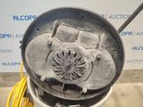 a metal drum with a blower on top of it