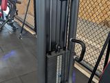 gym equipment in a gym with a chain link fence in the background