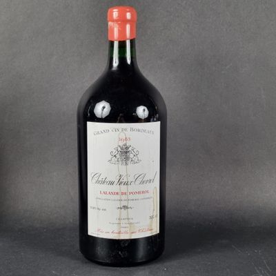 a bottle of wine sitting on top of a table next to a bottle of wine