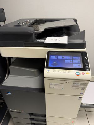 a multi - function printer sitting on top of a desk