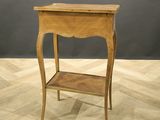 a small wooden table with a shelf on top of it
