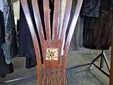 a wooden chair that is sitting under a table