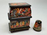 a small box with a lid that has a painting on it
