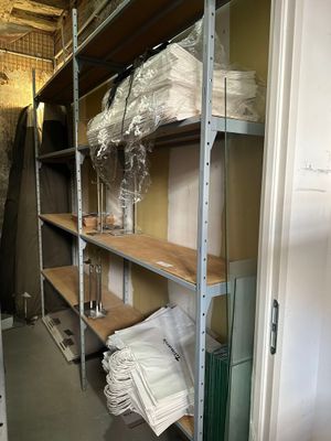 a room that has a shelf with a lot of items on it