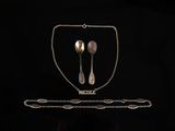 silverware on a black background with a chain around it