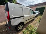 the van is parked on the side of the road next to a building