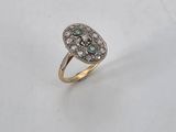 a diamond and emerald heart shaped ring