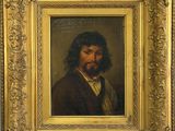 un tableau représentant un homme barbu dans un cadre en or