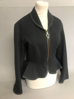 the jacket is black and has a gold zipper on the front