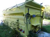 a yellow dump truck that is parked on the side of the road