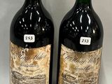 two bottles of wine sitting next to each other on a table