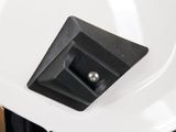 a white toilet with a black seat and a white sink
