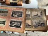 a person holding an old book with pictures on it