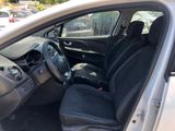 the interior of a car with the door open and the driver ' s seat down