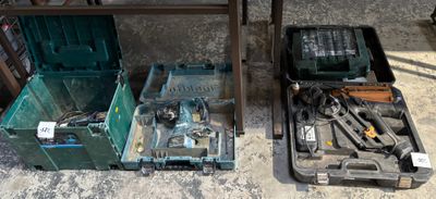 two boxes with tools in them sitting on the floor