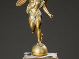 an antique clock with a statue of an angel on top of it
