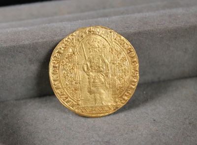 a gold coin sitting in a box on a table