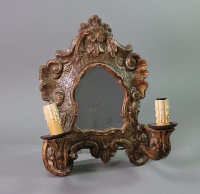 a mirror and a candle holder on a table